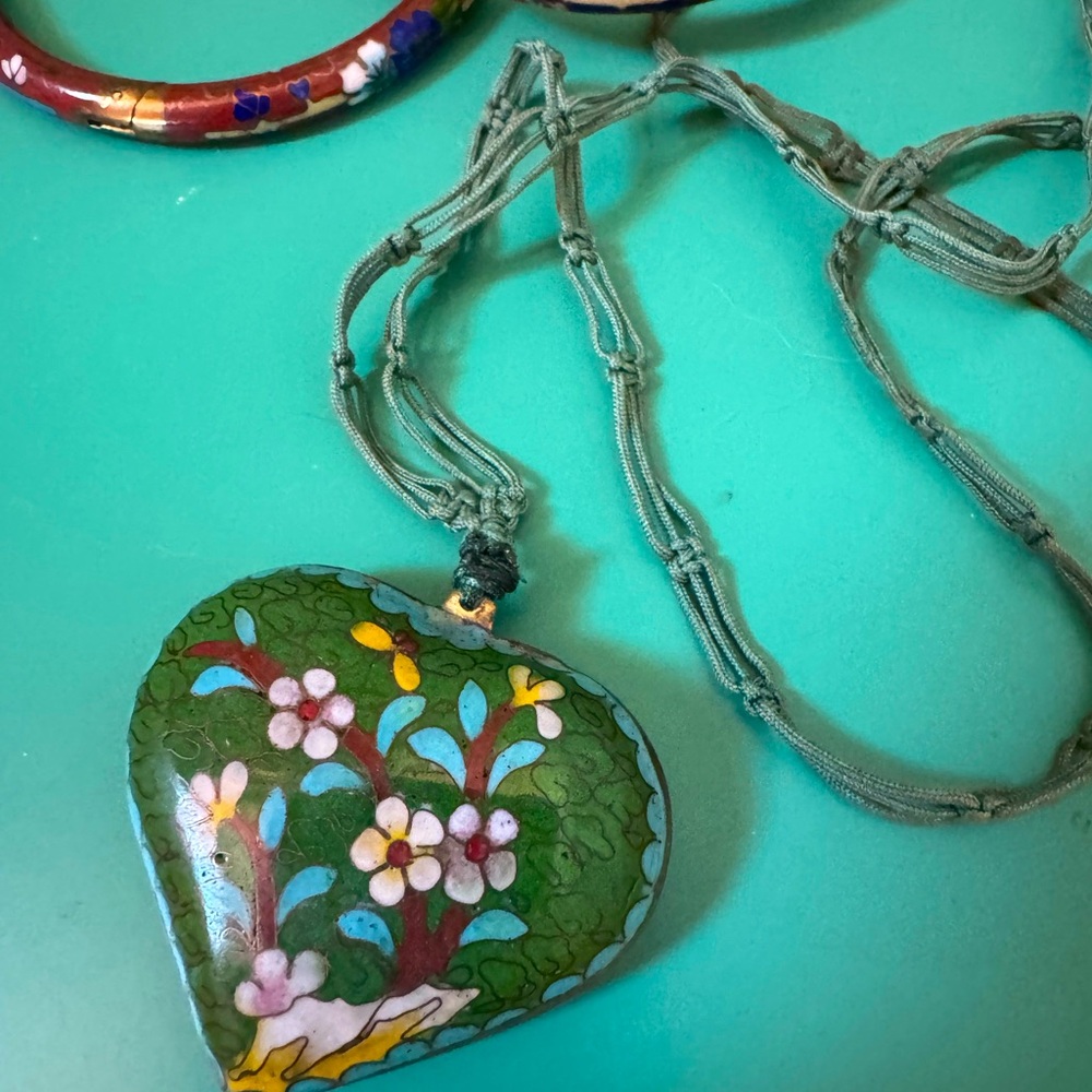 A collection of cloisonné bangle bracelet with necklace.Knotted linen with heart